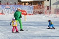 Posa Khutor, Sochi, Russia, January, 26, 2018. The instructor teaching little boys to go skiing on the child`s training slope in t