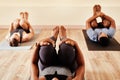 The pose that strengthens your core and more. a group of young men and women practicing yoga in a fitness class.