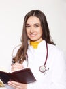 She poses in a doctor`s coat. With a book where she writes down her obligations.Ph1