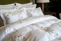 posh embroidered bedding set in a boutique hotel room Royalty Free Stock Photo