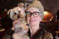 Posh senior woman with vintage leopard print look matching her dog Royalty Free Stock Photo