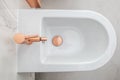 Posh White Bidet With Copper Fixture Royalty Free Stock Photo