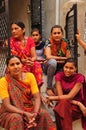 Poshina/Gujarat: Indian women sitting on a stairway