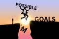 Businessman jumping over impossible and possible wording on cliff