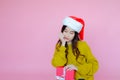 asia woman wearing long sleeve clothes on pink background with gift box in hand, Christmas or X'mas and happy new year Royalty Free Stock Photo