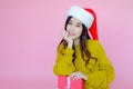 asia woman wearing long sleeve clothes on pink background with gift box in hand, Christmas or X'mas and happy new year Royalty Free Stock Photo