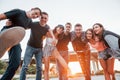 Posing for a camera. Group of young cheerful friends having fun together. Party outdoors Royalty Free Stock Photo