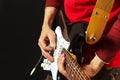 Posing hands of rock musician playing the guitar on black background Royalty Free Stock Photo