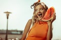 Face portrait of young lady posing with a watermelon piece