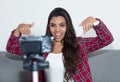 Posing latin american influencer girl recording video blog