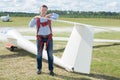 Posing next to glider Royalty Free Stock Photo