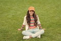 posing for photo. beautiful student teen girl in park. cute smiling confident schoolgirl relax on green grass. happy