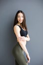 Posing woman with nice fitness body over gray background