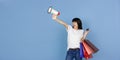 Portrait of young asian woman isolated on blue studio background