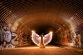 Posing Woman Light Painted With Wings in a Sewage Tunnel