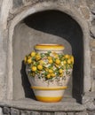 POSITANO, ITALY- JUNE, 14, 2019: shot of a ceamic pot, with lemons, on display at a roadside shop on the amalfi coast