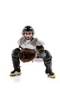 Baseball player, catcher in white sports uniform and equipment practicing isolated on a white studio background. Royalty Free Stock Photo