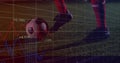 Positioning player\'s legs in red socks controlling ball on pitch at night with analytics graph Royalty Free Stock Photo