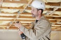 positive adult builder handyman working with electric drill indoors Royalty Free Stock Photo