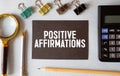 positive affirmations - file cabinet label, bronze holder against grunge and scratched wood