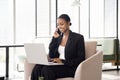 Positive African American business expert woman talking on mobile phone Royalty Free Stock Photo
