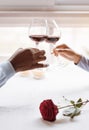 Positive African American couple drinking wine in the restaurant