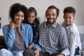 Positive African family couple and two cute little sibling kids Royalty Free Stock Photo