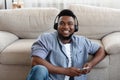 Positive African Guy Listening Music With Headphones And Smartphone At Home Royalty Free Stock Photo