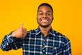 Positive African Man Gesturing Thumbs-Up Standing Over Yellow Background Royalty Free Stock Photo