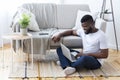 Positive african man surfing internet on laptop Royalty Free Stock Photo