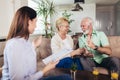 Aged couple consulting with insurance agent