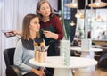 Aged woman beautician applying makeup to young female client Royalty Free Stock Photo