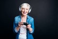 Positive aged woman playing video games Royalty Free Stock Photo