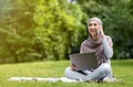 Positive arab girl freelancer working at park