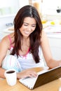 Positive asian woman using her laptop at home Royalty Free Stock Photo