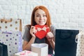 Positive awesome girl holding a red box