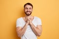 Positive awesome man in white T-shirt thinking about something