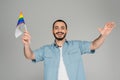 Positive and bearded homosexual man holding