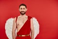 positive bearded man dressed as cupid