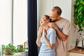 Positive bearded man in homewear hugging