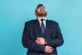 Positive bearded man wearing official style suit holding his belly and laughing out loud, chuckling Royalty Free Stock Photo