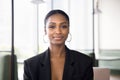 Positive beautiful African American businesswoman in formal jacket head shot Royalty Free Stock Photo