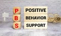 Positive behavior support symbol. Concept words Positive behavior support on wooden blocks.