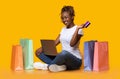 Positive black girl shopping online, using laptop and credit card Royalty Free Stock Photo