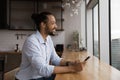 Positive black male renter of apartment dream distracted from cell