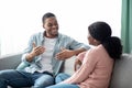 Positive black man and woman having conversation at home Royalty Free Stock Photo