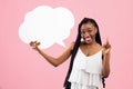 Positive black woman with afro bunches holding blank speech bubble, making IDEA gesture on pink background, mockup Royalty Free Stock Photo