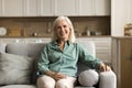 Positive blonde elderly woman relaxing at home Royalty Free Stock Photo