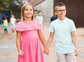 Positive boy and girl walking outdoors