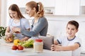 Positive boy using tablet in the kitchen